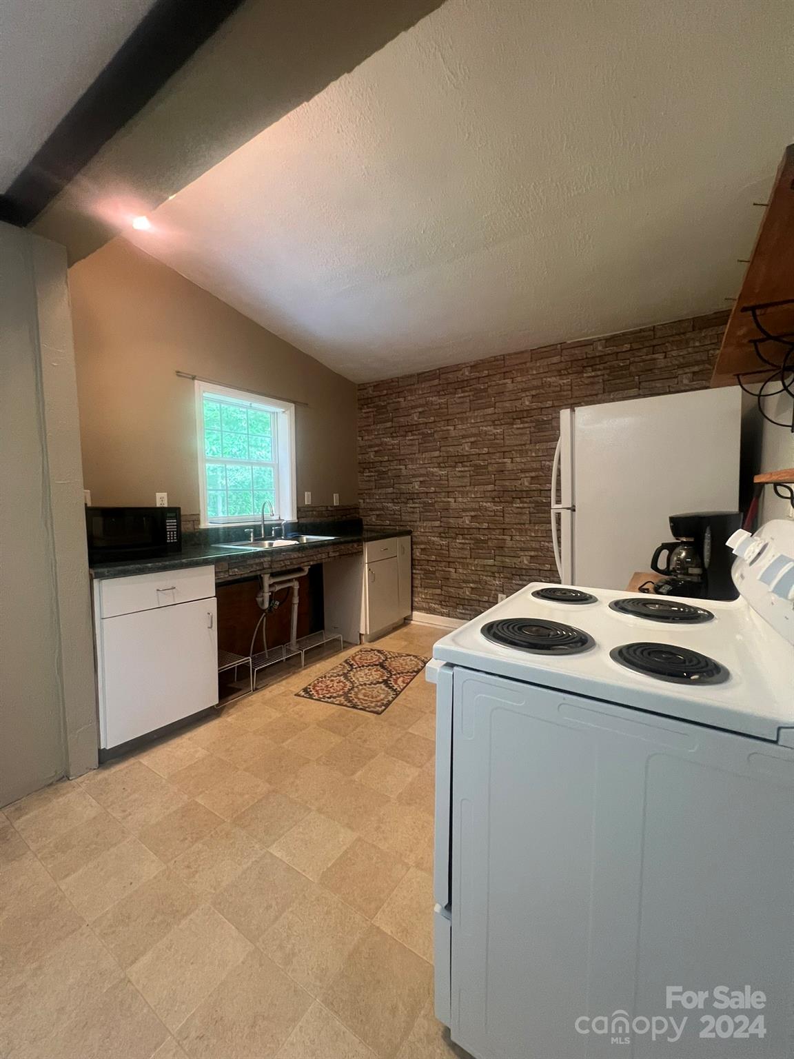 1323 Locust Grove Road Hendersonville, NC 28792 - Photo 20 of 40 a kitchen that has a sink and a stove