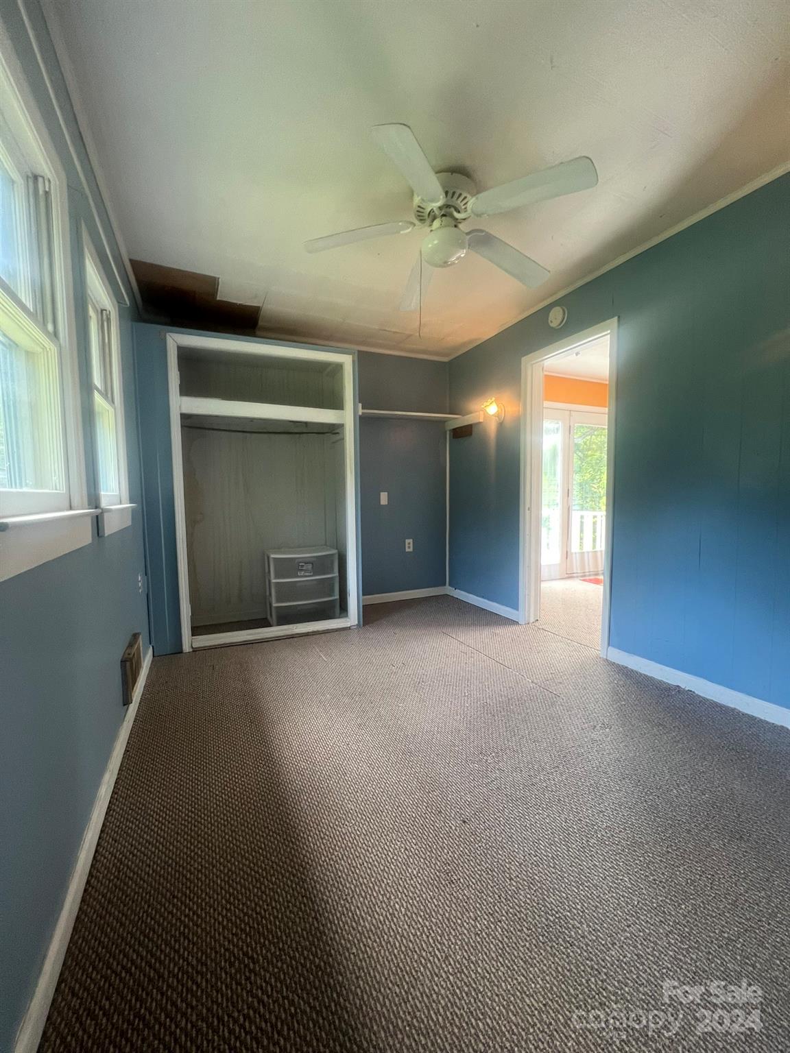 1323 Locust Grove Road Hendersonville, NC 28792 - Photo 25 of 40 an empty room with windows and fan