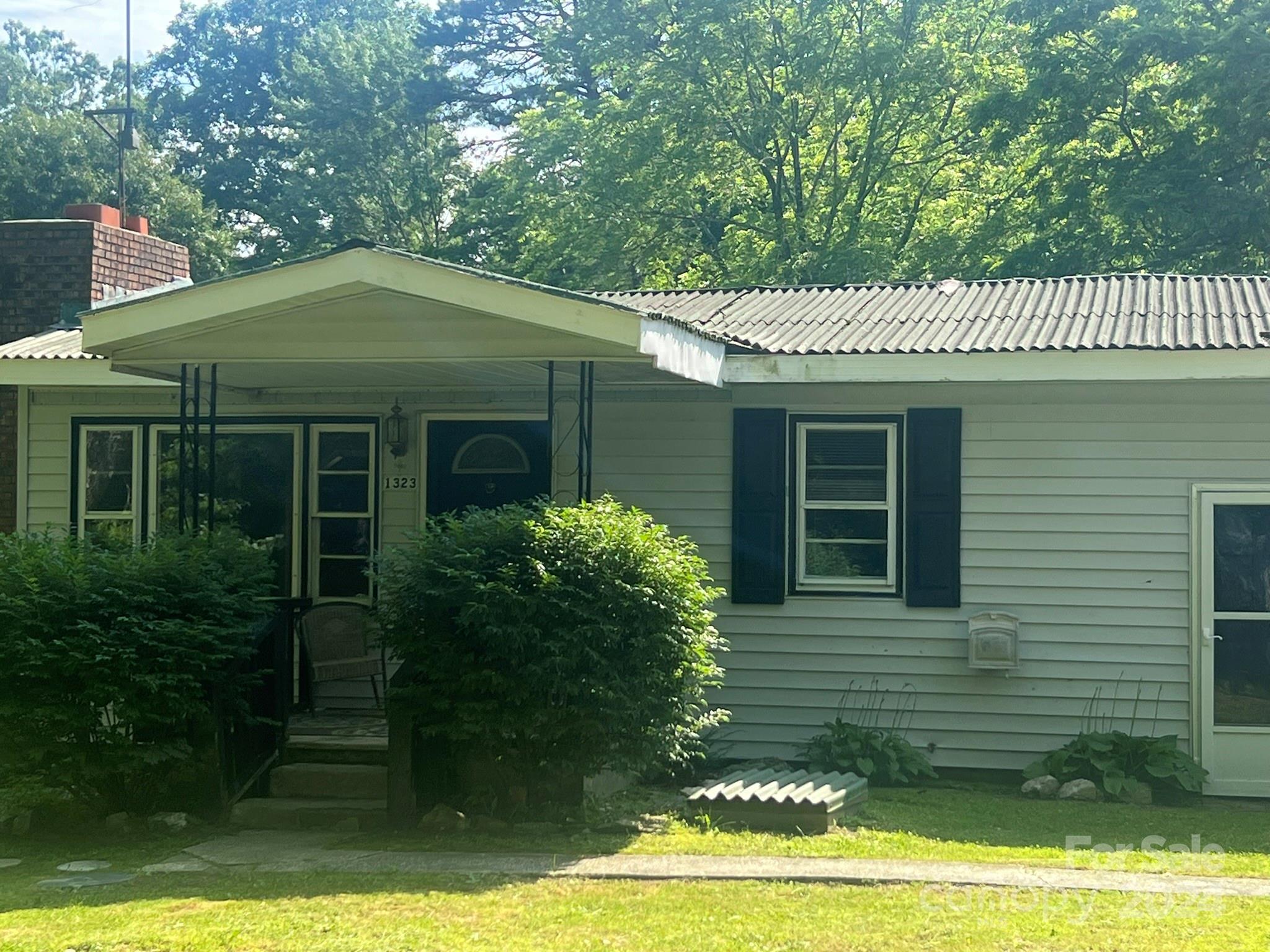 1323 Locust Grove Road Hendersonville, NC 28792 - Photo 29 of 40 a front view of a house with garden