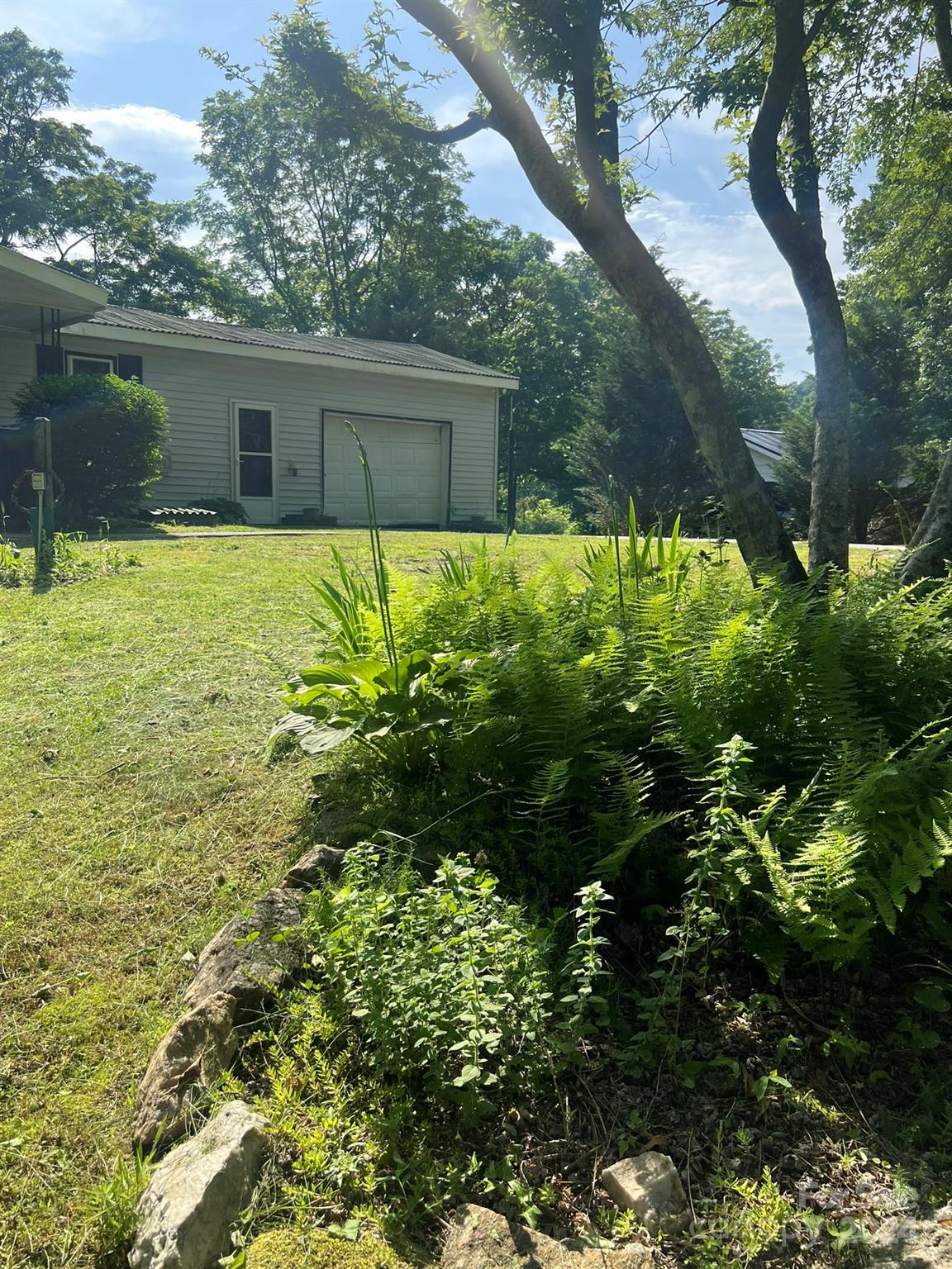 1323 Locust Grove Road Hendersonville, NC 28792 - Photo 35 of 40 a view of a house with a yard