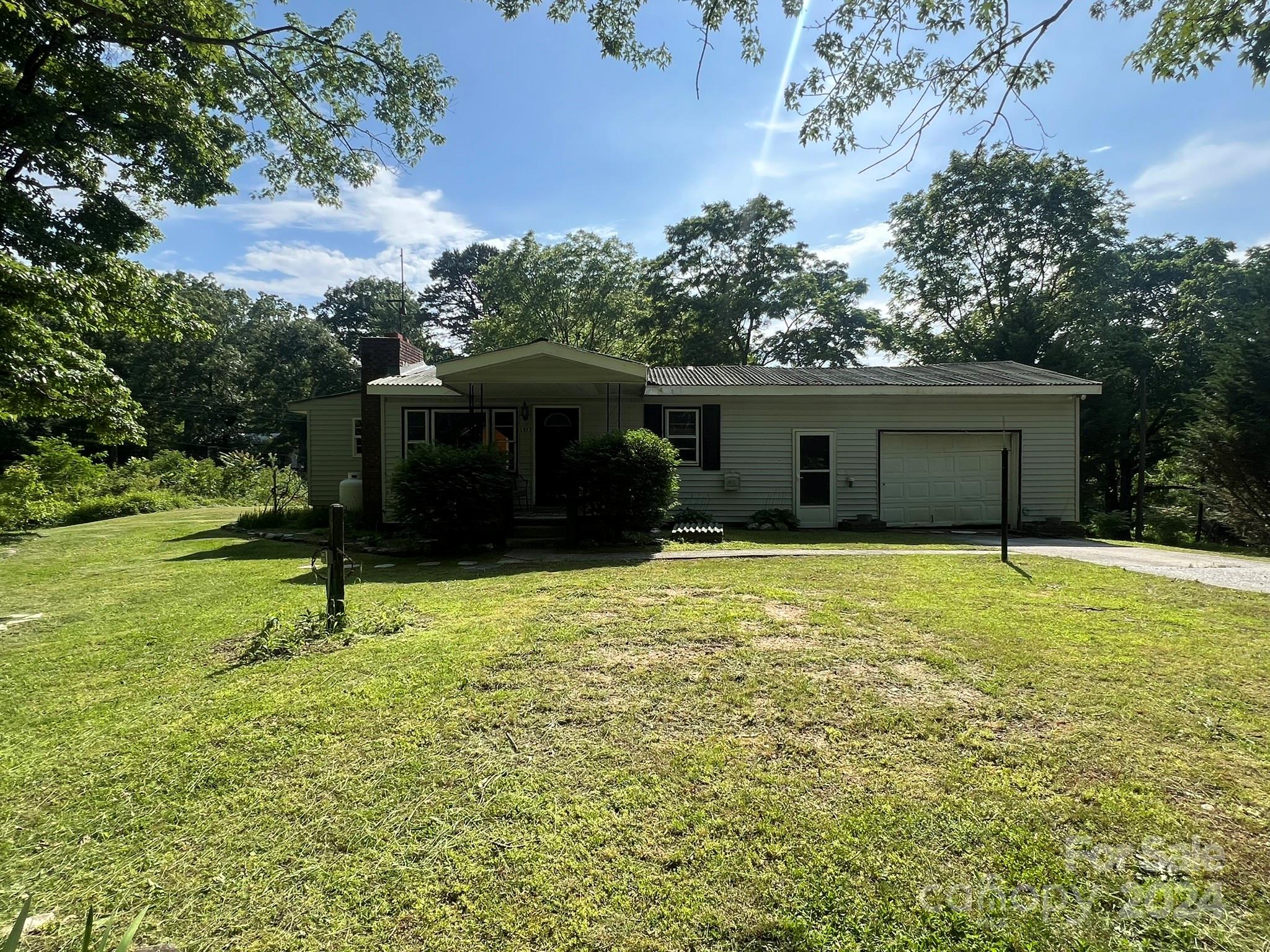 1323 Locust Grove Road Hendersonville, NC 28792 - Photo 39 of 40 a house with garden in front of it