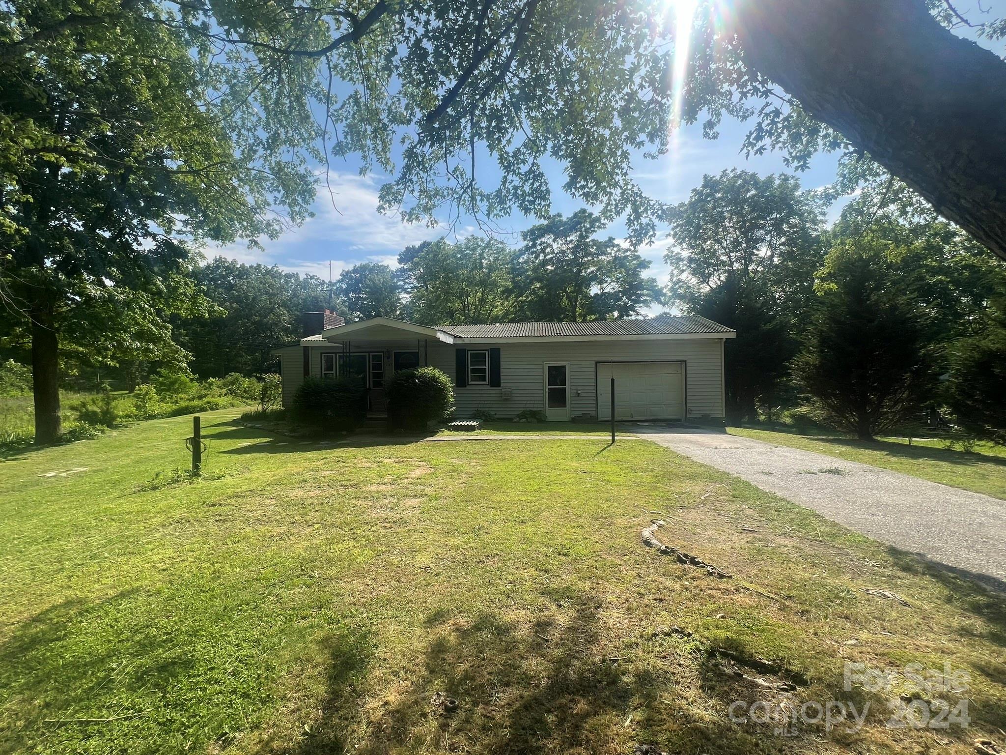 1323 Locust Grove Road Hendersonville, NC 28792 - Photo 6 of 40 a yellow house with a yard