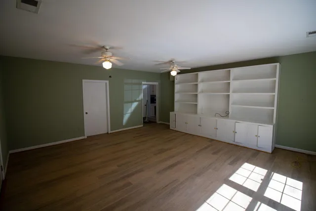 an empty room with a empty space and windows