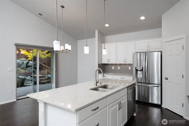 a kitchen with a sink a counter space and stainless steel appliances