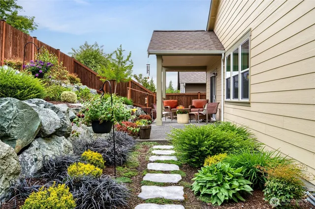 a view of a house with a backyard and sitting area