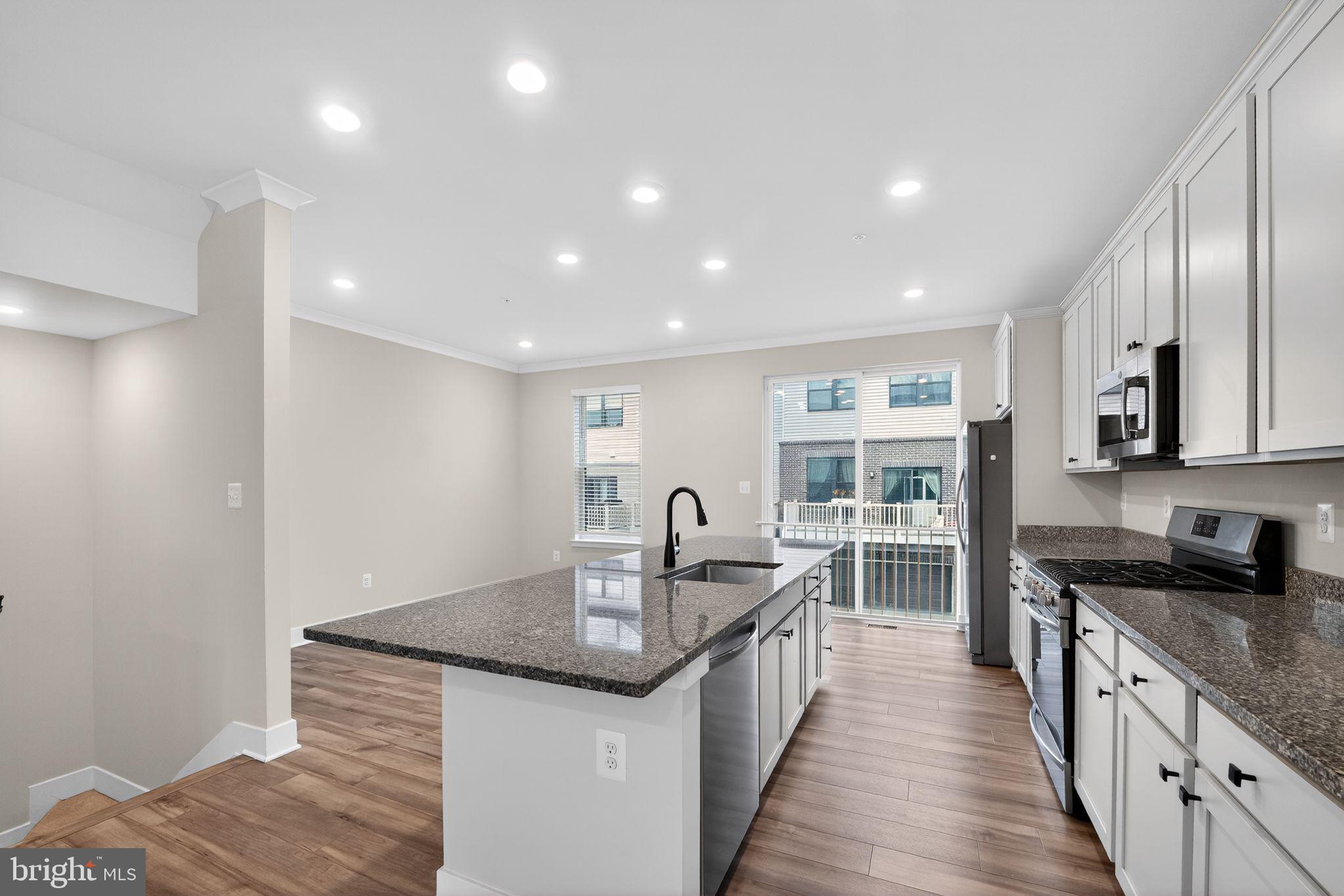 4300 Roland Heights Avenue Baltimore, MD 21211 - Photo 11 of 37 a kitchen with granite countertop a sink and cabinets