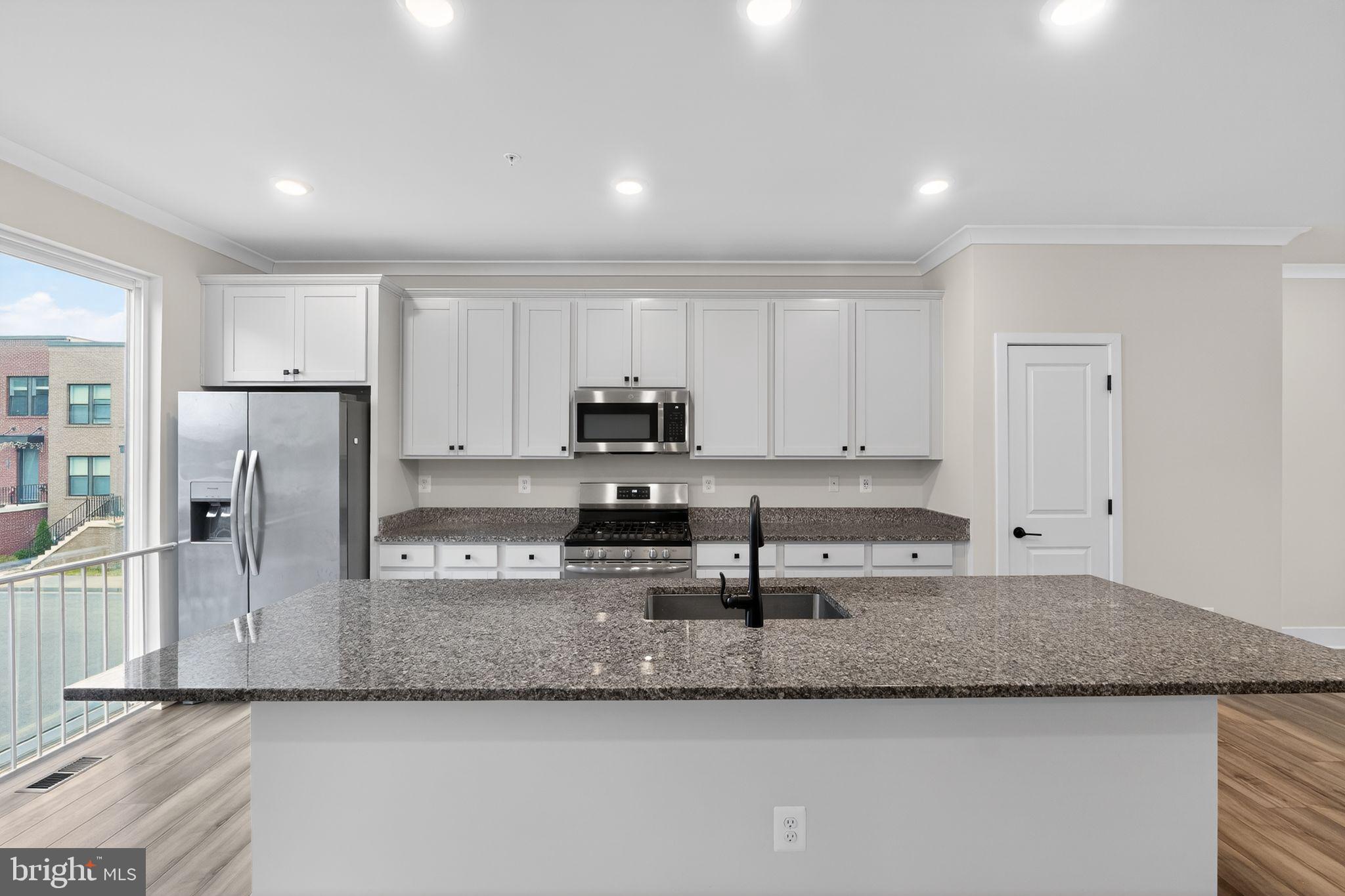 4300 Roland Heights Avenue Baltimore, MD 21211 - Photo 14 of 37 a kitchen with stainless steel appliances granite countertop a sink a stove and a refrigerator