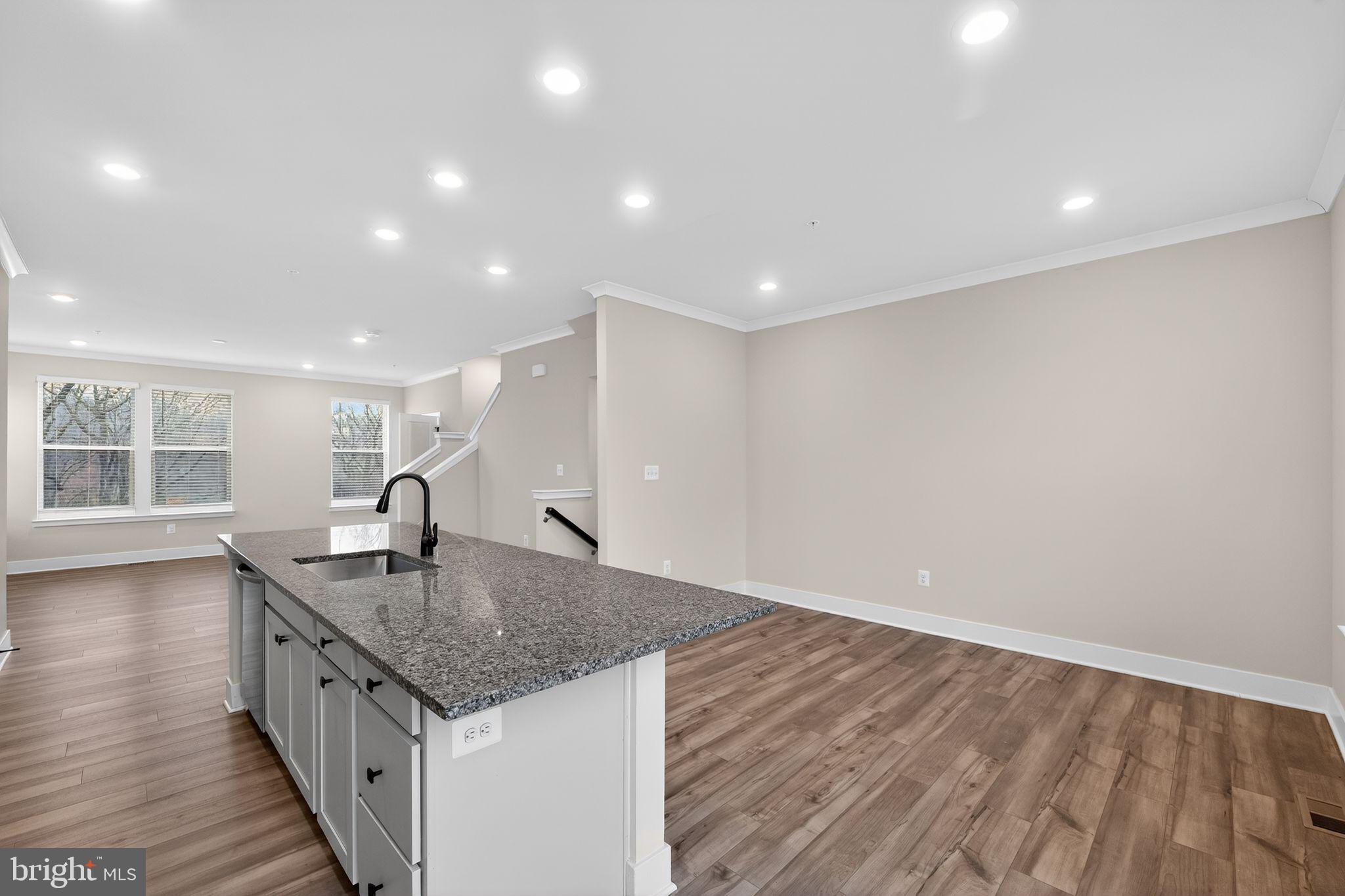 4300 Roland Heights Avenue Baltimore, MD 21211 - Photo 18 of 37 a kitchen with a sink and dishwasher with wooden floor