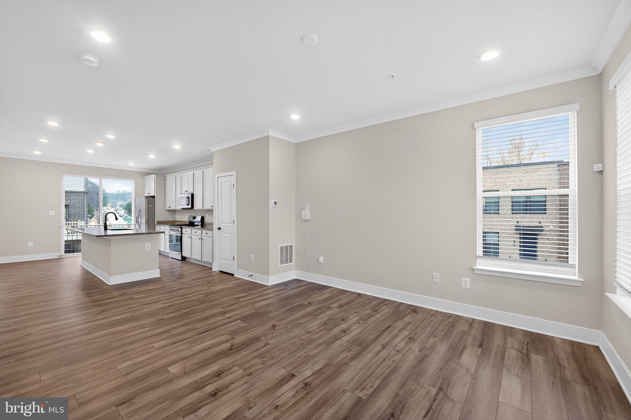 4300 Roland Heights Avenue Baltimore, MD 21211 - Photo 22 of 37 a view of empty room with wooden floor and windows