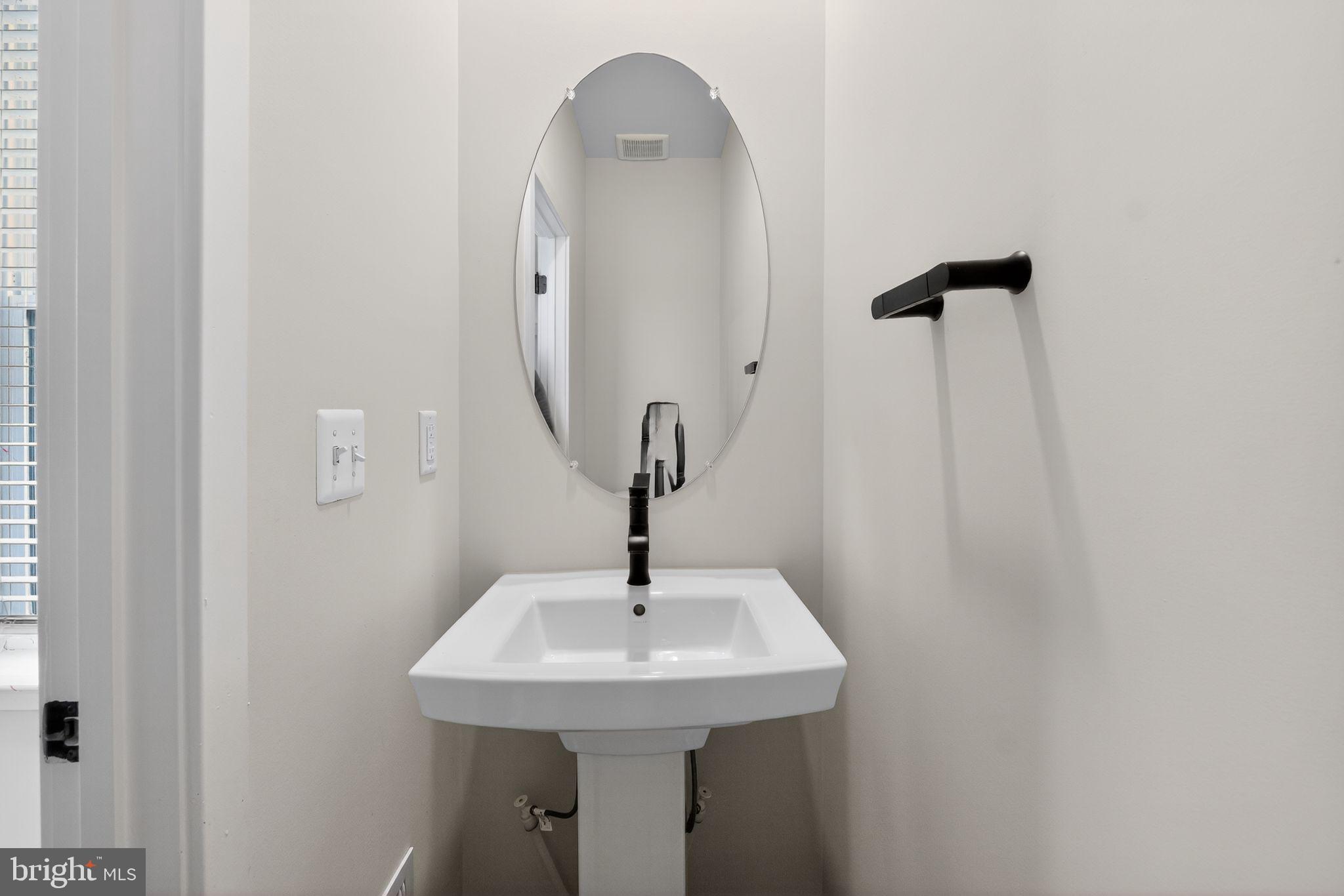 4300 Roland Heights Avenue Baltimore, MD 21211 - Photo 23 of 37 a bathroom with a sink and mirror