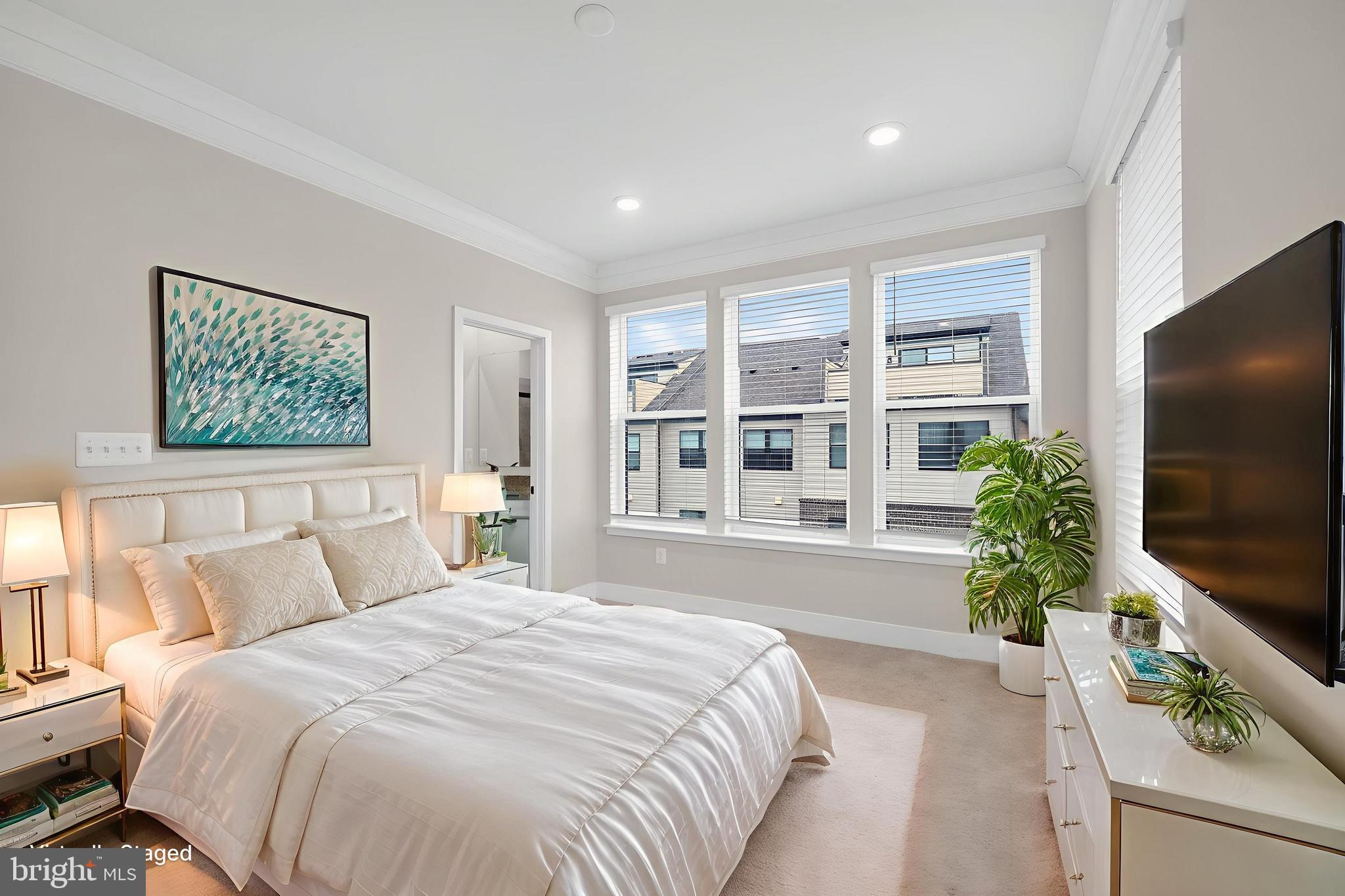 4300 Roland Heights Avenue Baltimore, MD 21211 - Photo 26 of 37 a spacious bedroom with a large bed and a flat screen tv