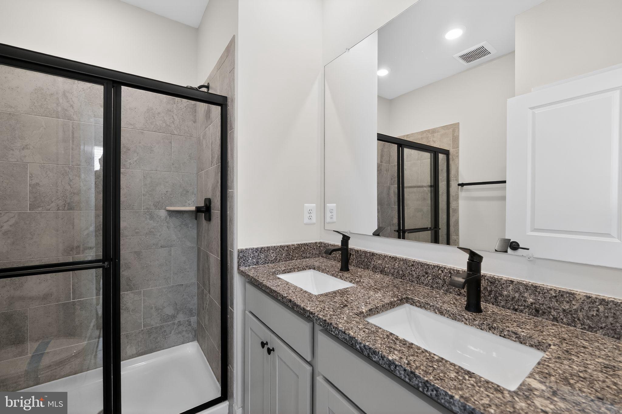 4300 Roland Heights Avenue Baltimore, MD 21211 - Photo 31 of 37 a bathroom with a granite countertop sink and a mirror