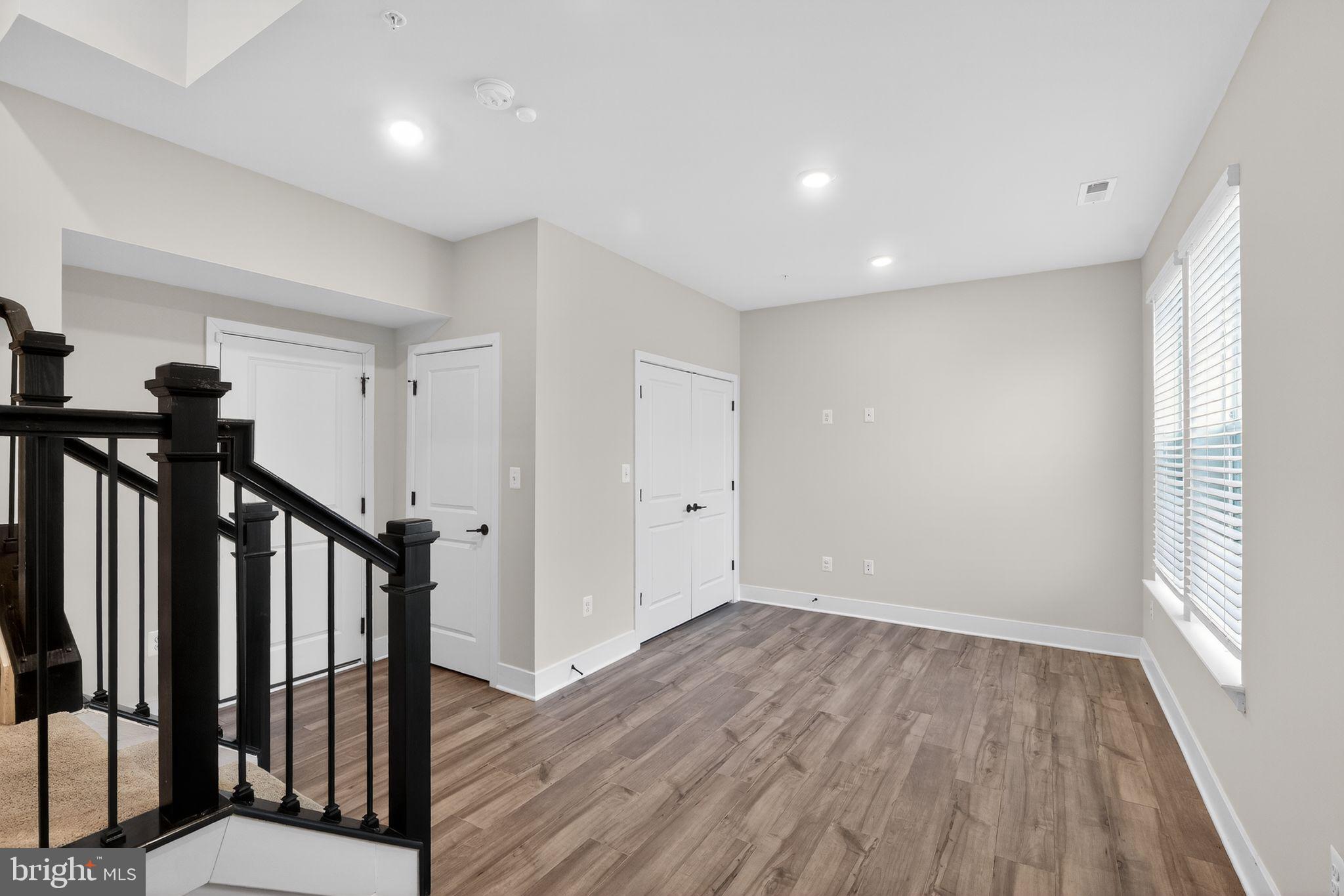 4300 Roland Heights Avenue Baltimore, MD 21211 - Photo 5 of 37 a view of a hallway with wooden floor and stairs