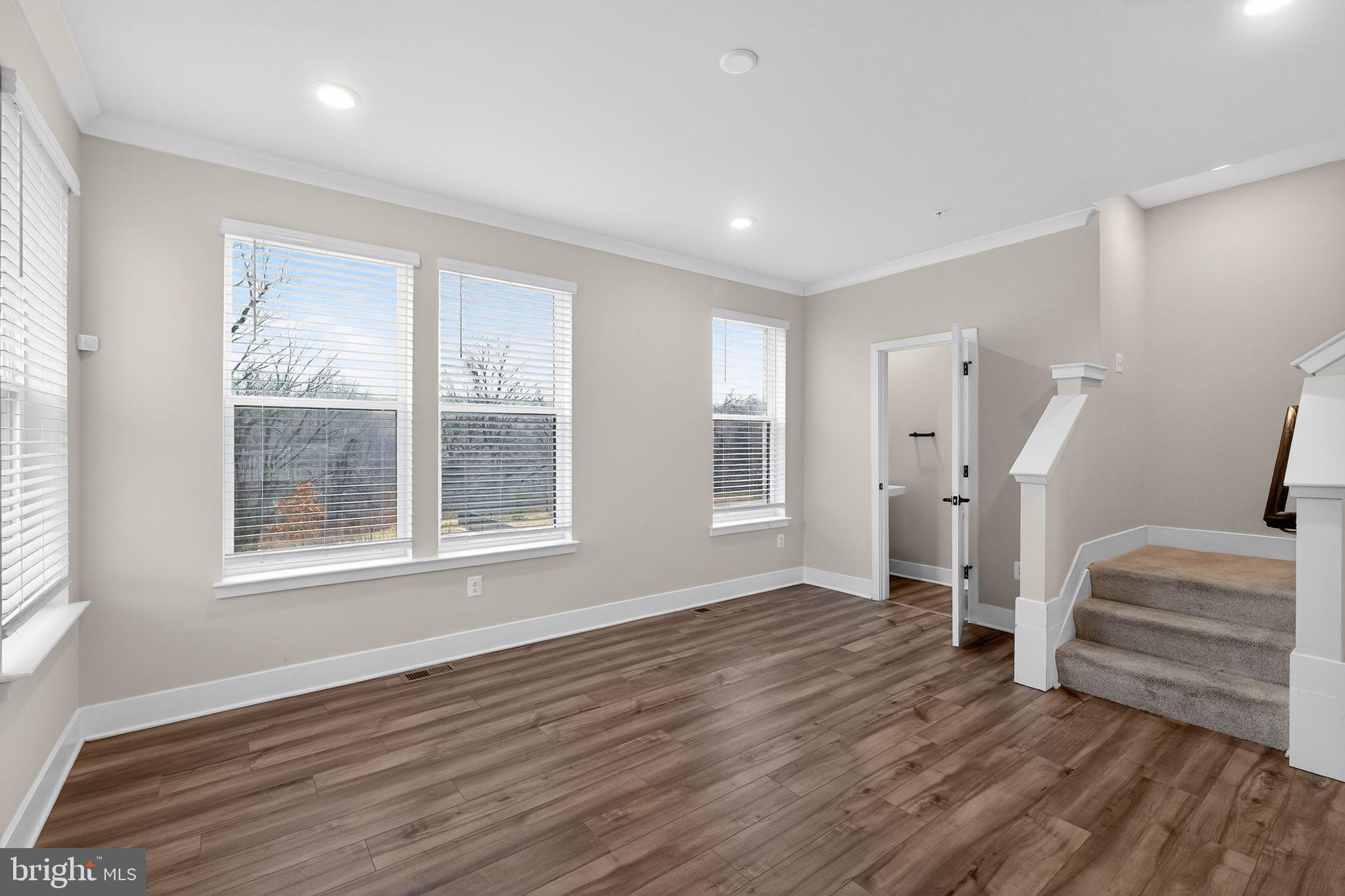 4300 Roland Heights Avenue Baltimore, MD 21211 - Photo 8 of 37 a view of empty room with wooden floor and fan