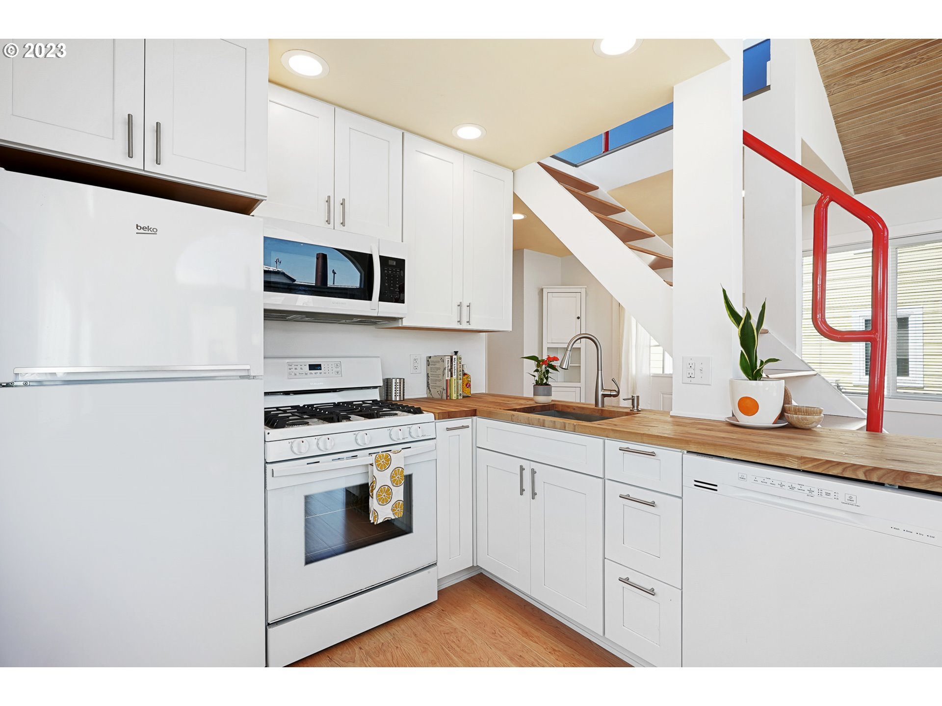 205 North Bridgeton Road, Unit 6 Portland, OR 97217 - Photo 11 of 22 a kitchen with stainless steel appliances granite countertop a sink and a stove