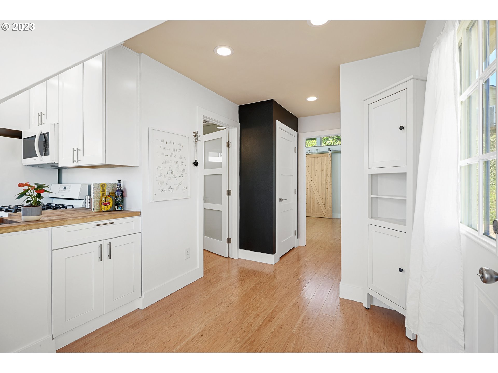 205 North Bridgeton Road, Unit 6 Portland, OR 97217 - Photo 12 of 22 a kitchen with cabinets and wooden floor