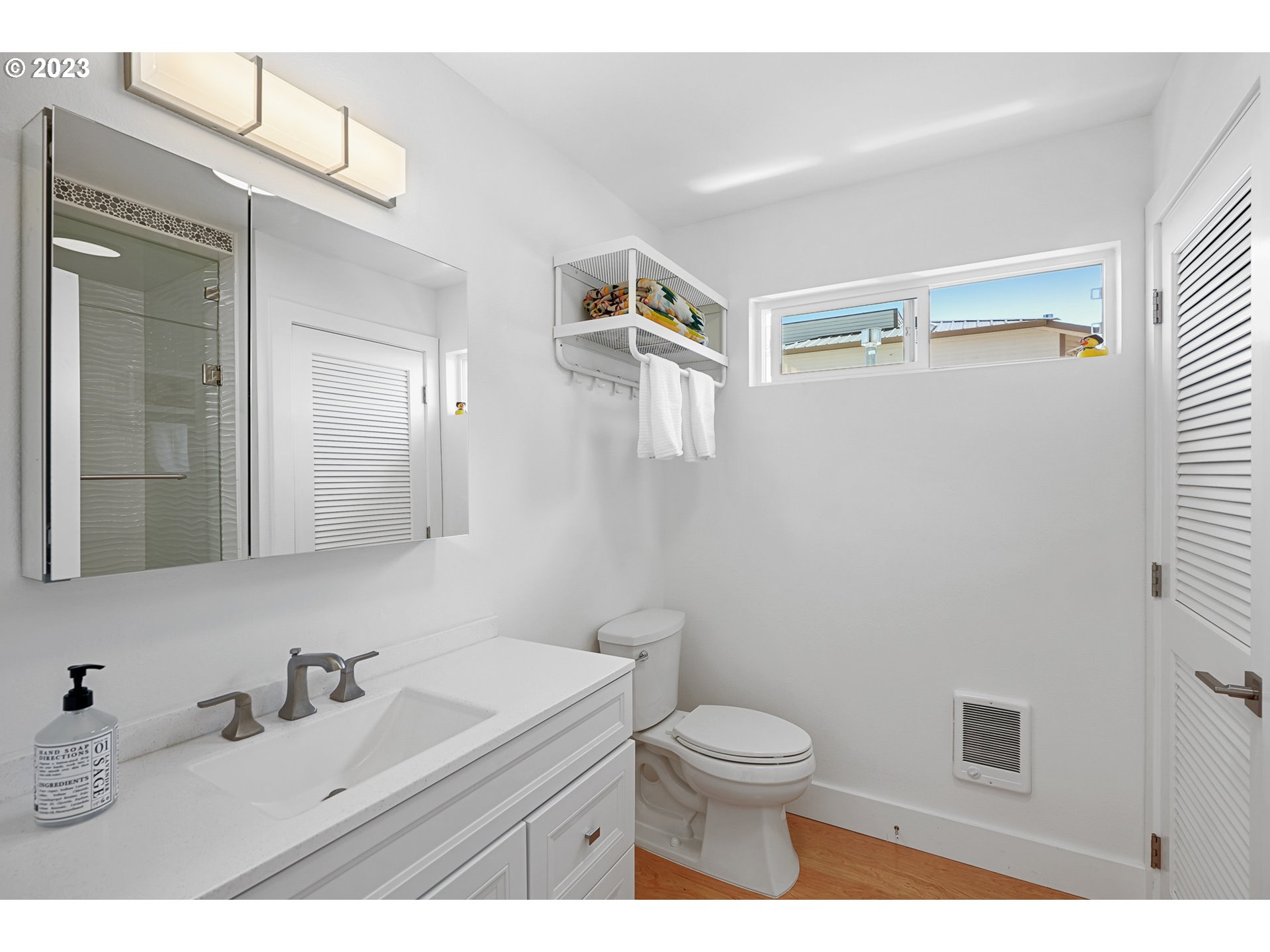 205 North Bridgeton Road, Unit 6 Portland, OR 97217 - Photo 13 of 22 a bathroom with a sink a toilet and mirror