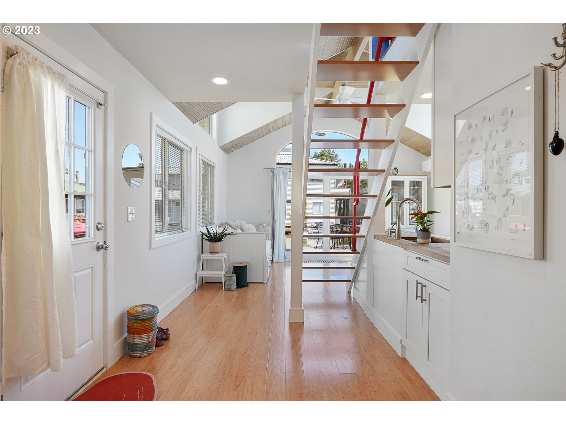 205 North Bridgeton Road, Unit 6 Portland, OR 97217 - Photo 7 of 22 a open kitchen with stainless steel appliances kitchen island granite countertop a refrigerator and a wooden floors
