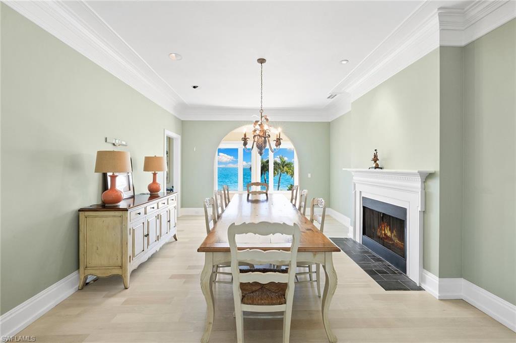 1069 Bird Lane Sanibel, FL 33957 - Photo 16 of 46 a living room with furniture a fireplace and a chandelier