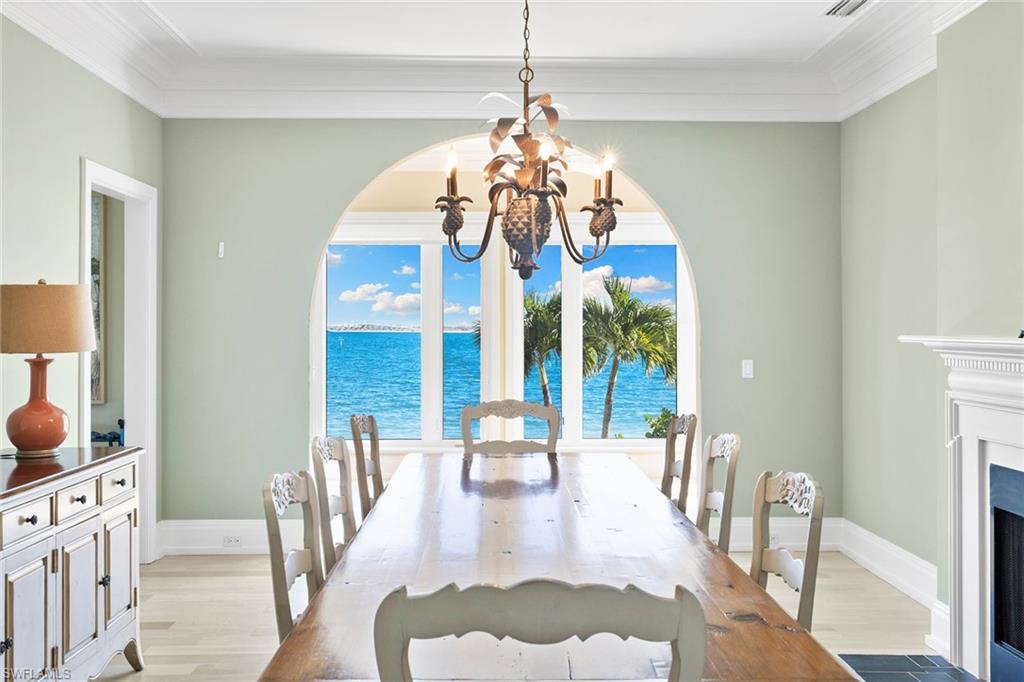 1069 Bird Lane Sanibel, FL 33957 - Photo 17 of 46 a view of a dining room with furniture wooden floor and chandelier