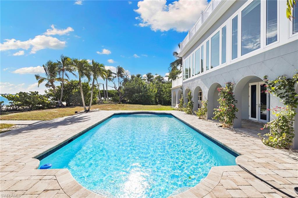 1069 Bird Lane Sanibel, FL 33957 - Photo 29 of 46 a view of swimming pool with outdoor seating and plants