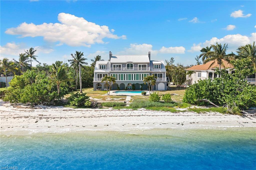 1069 Bird Lane Sanibel, FL 33957 - Photo 33 of 46 a view of a house with a yard and lawn chairs