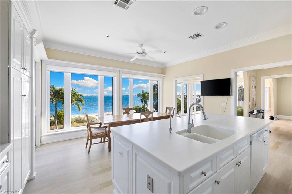 1069 Bird Lane Sanibel, FL 33957 - Photo 9 of 46 a kitchen with sink stove and refrigerator