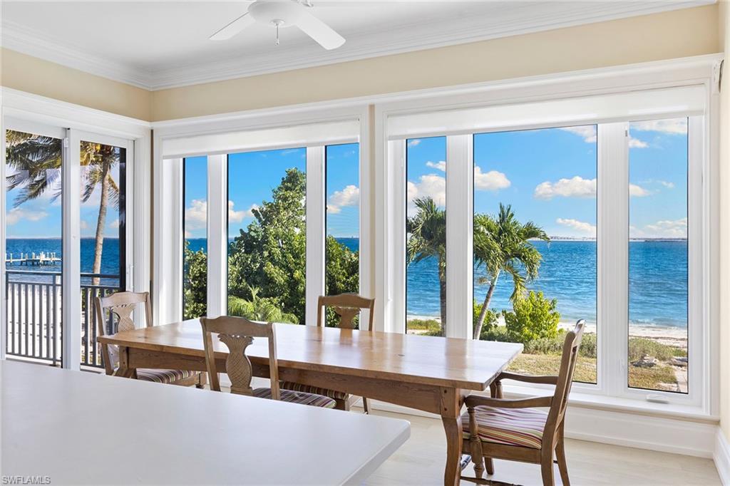 1069 Bird Lane Sanibel, FL 33957 - Photo 10 of 46 a dining room with furniture and large windows