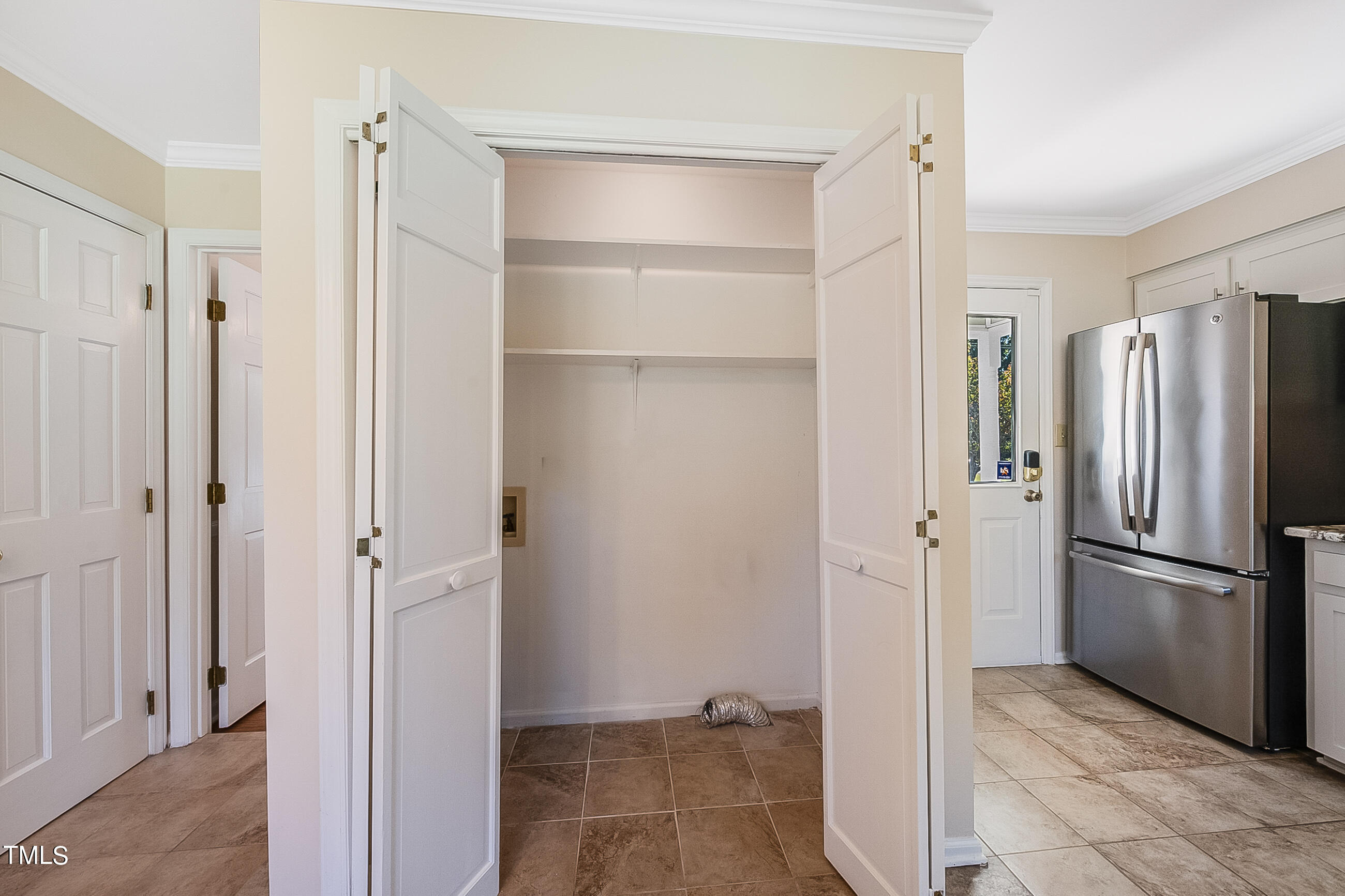 10024 Joe Leach Road Raleigh, NC 27603 - Photo 11 of 26 a view of a refrigerator in a kitchen