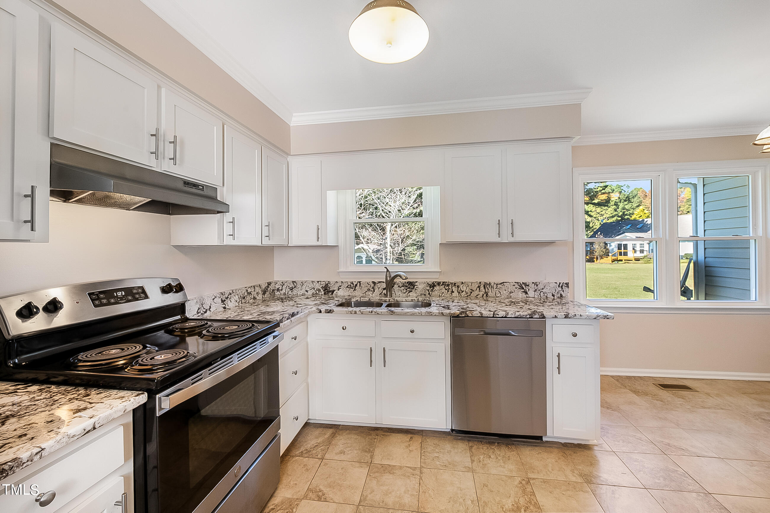 10024 Joe Leach Road Raleigh, NC 27603 - Photo 20 of 26 a kitchen with stainless steel appliances granite countertop a stove and a sink