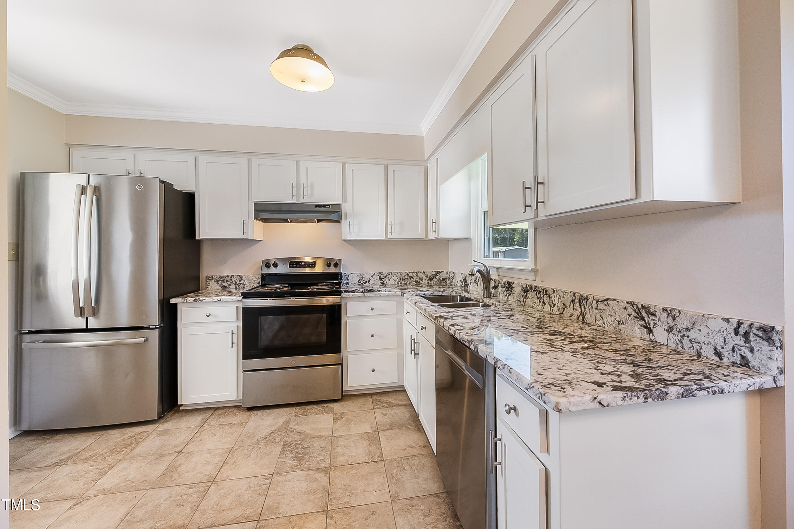10024 Joe Leach Road Raleigh, NC 27603 - Photo 22 of 26 a kitchen with a stove top oven and refrigerator
