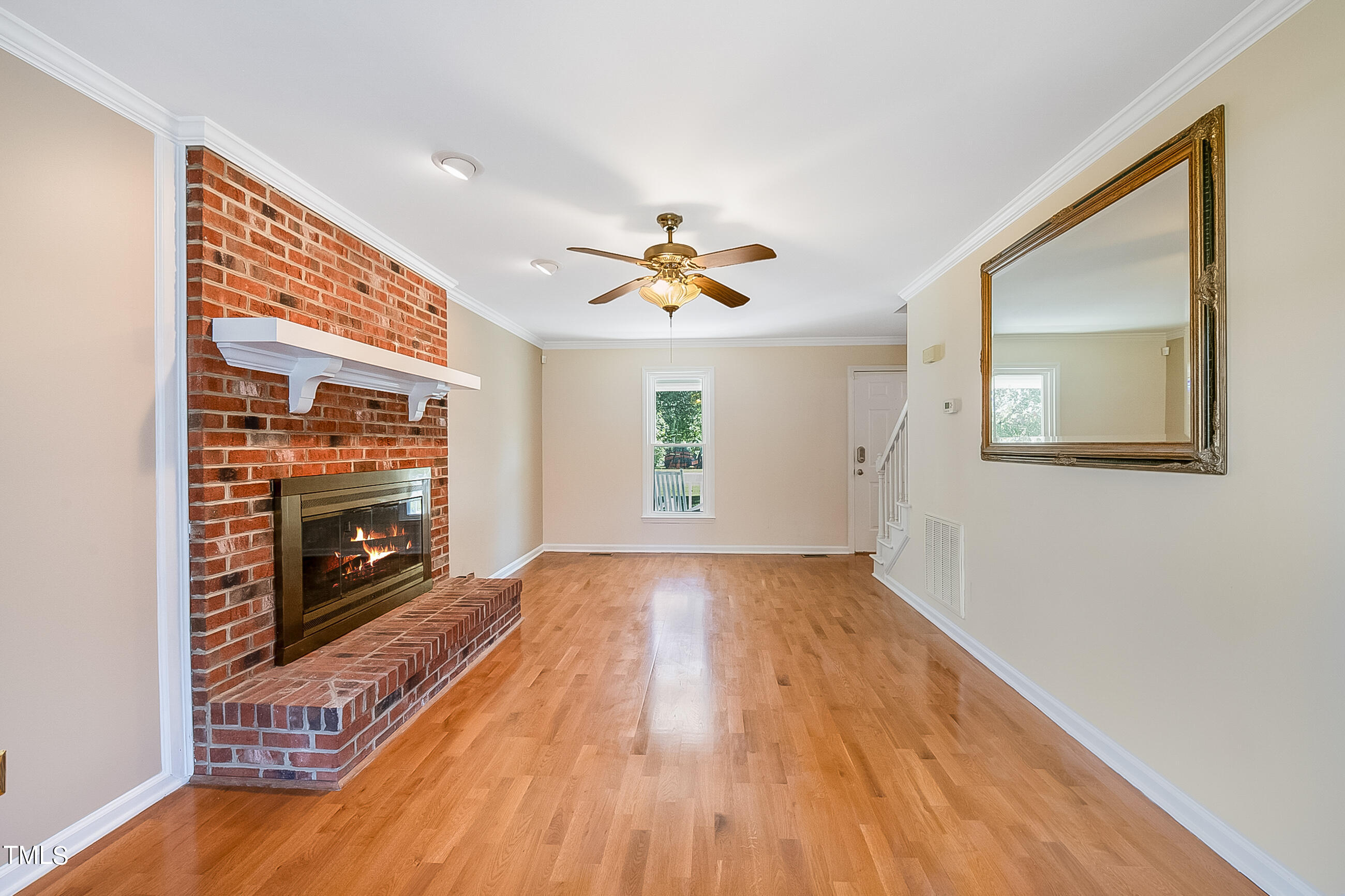 10024 Joe Leach Road Raleigh, NC 27603 - Photo 24 of 26 a view of an empty room with a fireplace and a window