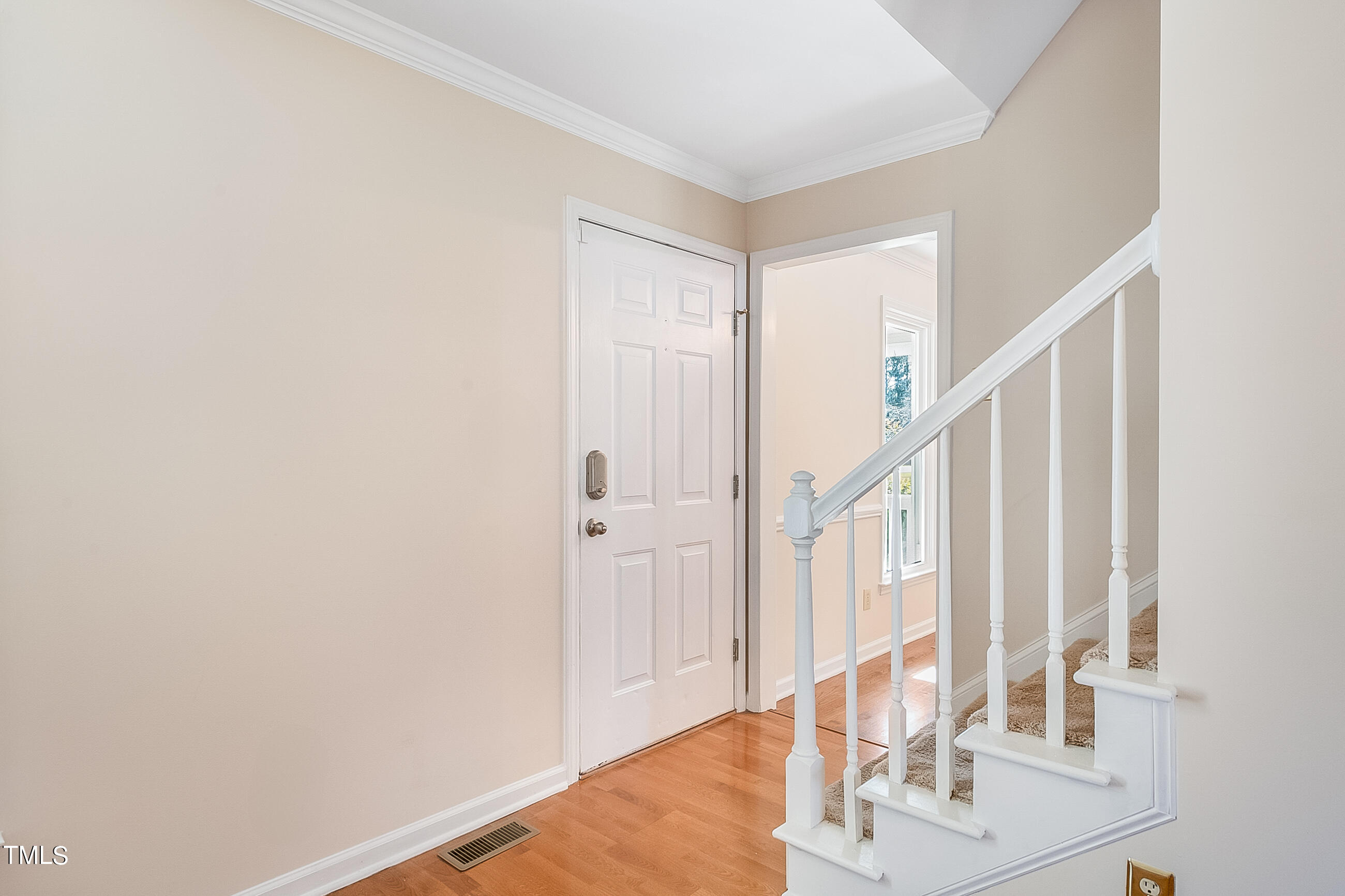 10024 Joe Leach Road Raleigh, NC 27603 - Photo 9 of 26 a view of a hallway with wooden floor and entryway