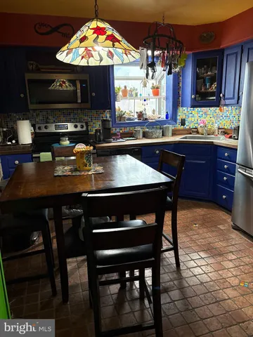 a kitchen with a wooden table and chairs
