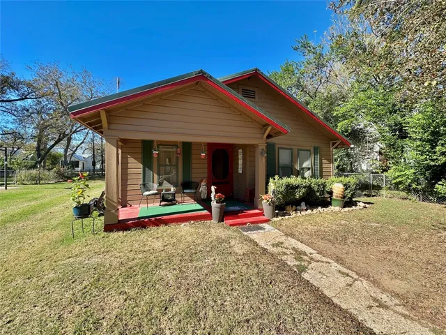 a view of a house with porch and chairs