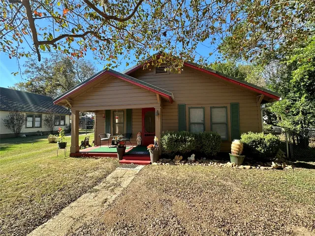 a front view of a house with garden