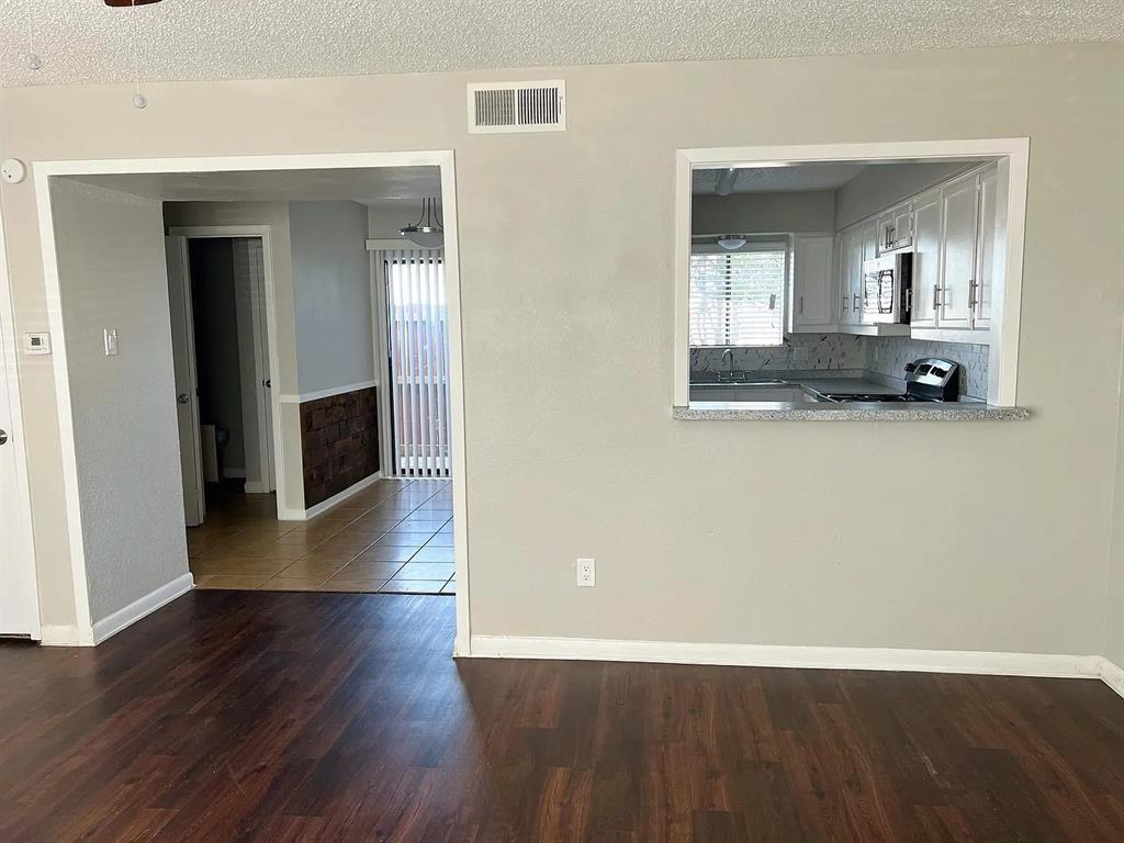 514 East Belt Line Road, Unit B13 DeSoto, TX 75115 - Photo 7 of 28 an empty room with wooden floor and mirror