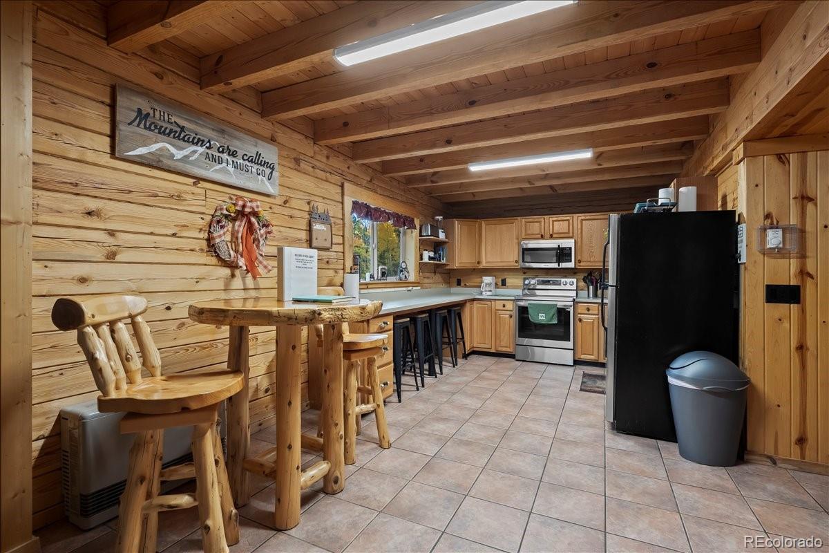 1119 Venture Road Fairplay, CO 80440 - Photo 15 of 49 a kitchen with table chairs and refrigerator