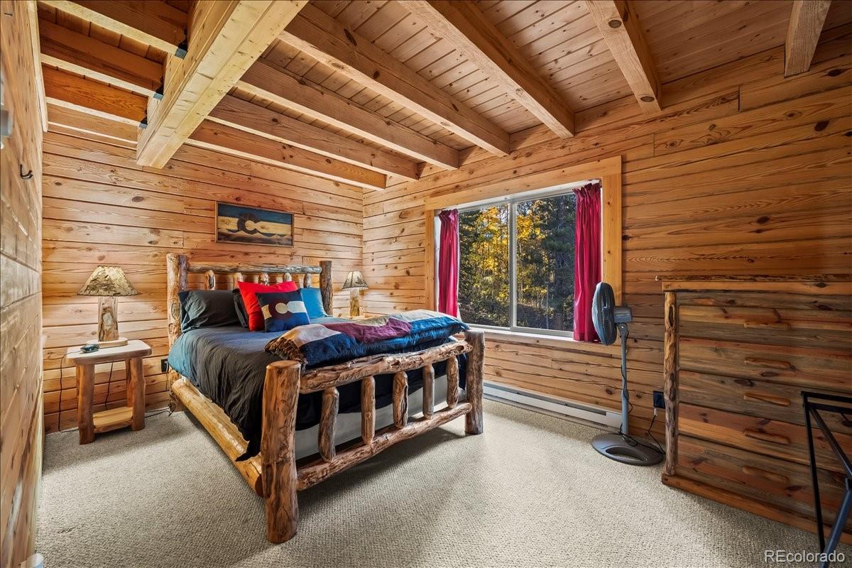 1119 Venture Road Fairplay, CO 80440 - Photo 22 of 49 a bedroom with a bed and a ceiling fan