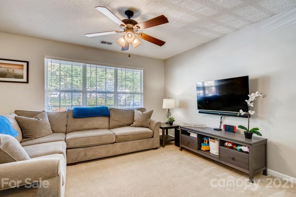 8210 Rudolph Road Charlotte, NC 28216 - Photo 3 of 11 a living room with furniture and a flat screen tv