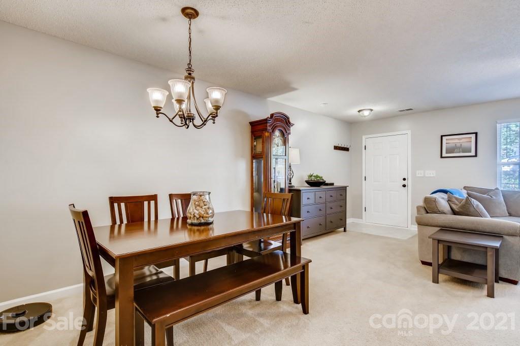 8210 Rudolph Road Charlotte, NC 28216 - Photo 4 of 11 a living room with furniture and a chandelier