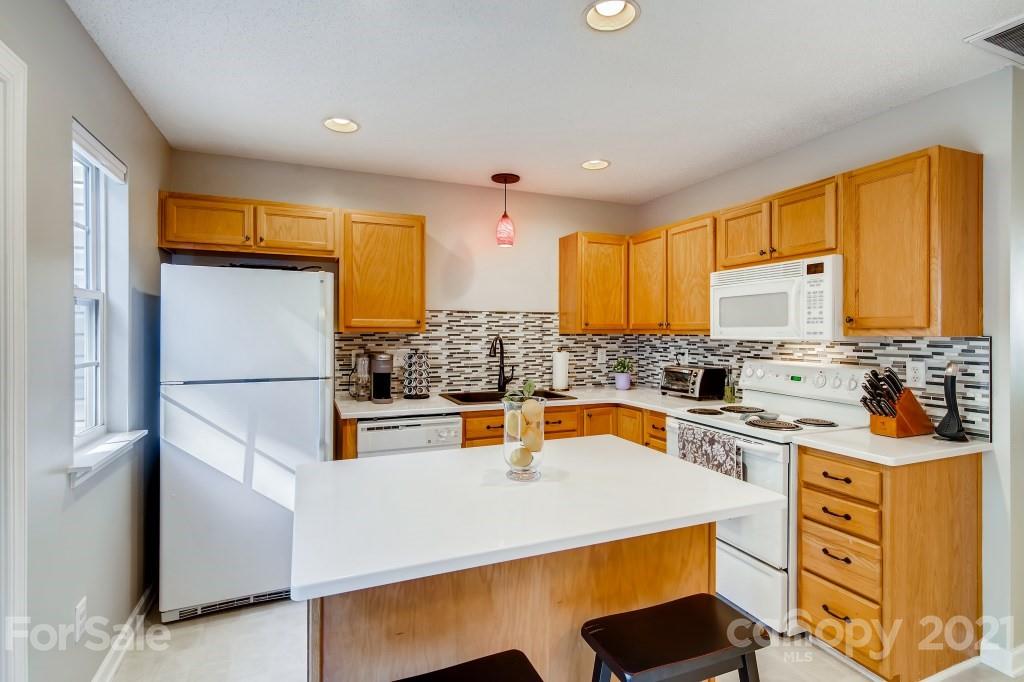 8210 Rudolph Road Charlotte, NC 28216 - Photo 6 of 11 a kitchen with stainless steel appliances a stove a sink and a refrigerator