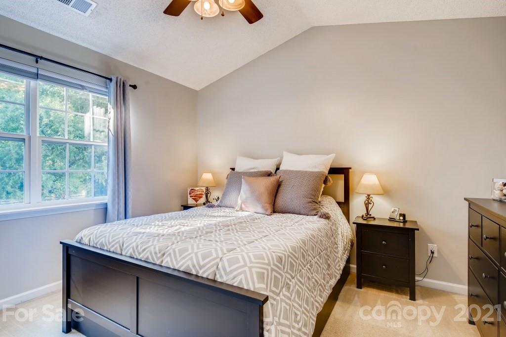 8210 Rudolph Road Charlotte, NC 28216 - Photo 7 of 11 a bedroom with a bed and a tv