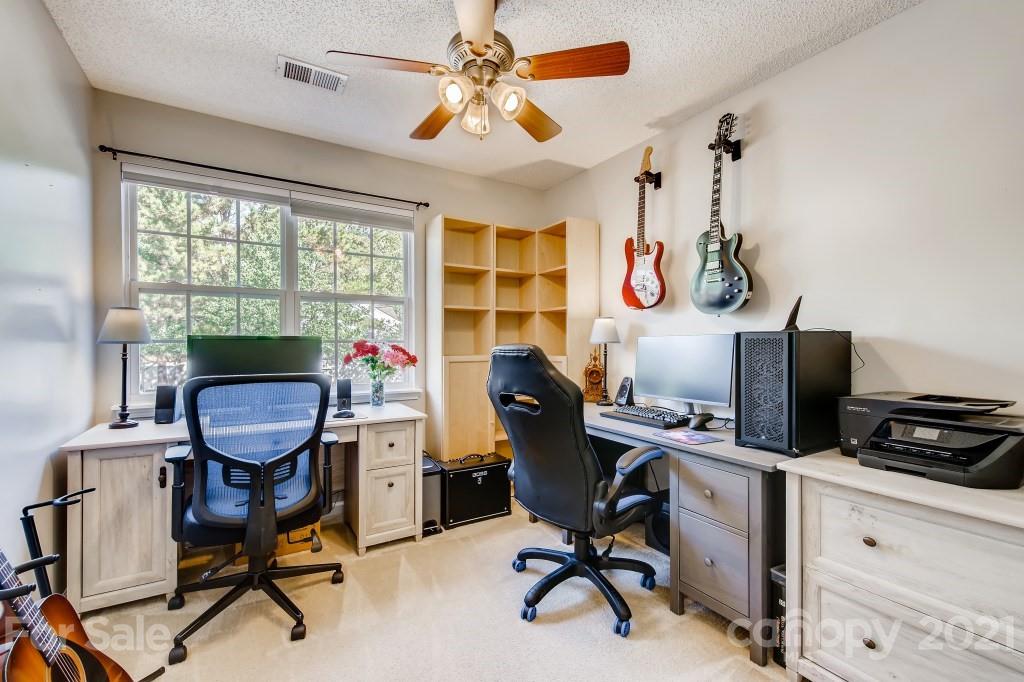 8210 Rudolph Road Charlotte, NC 28216 - Photo 9 of 11 a view of a workspace with furniture and a window