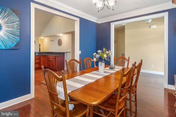 a view of a dining room with furniture and chandelier