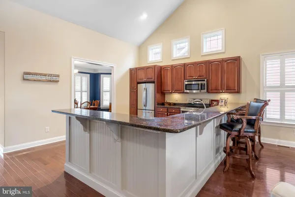 a kitchen with stainless steel appliances granite countertop a sink and stove