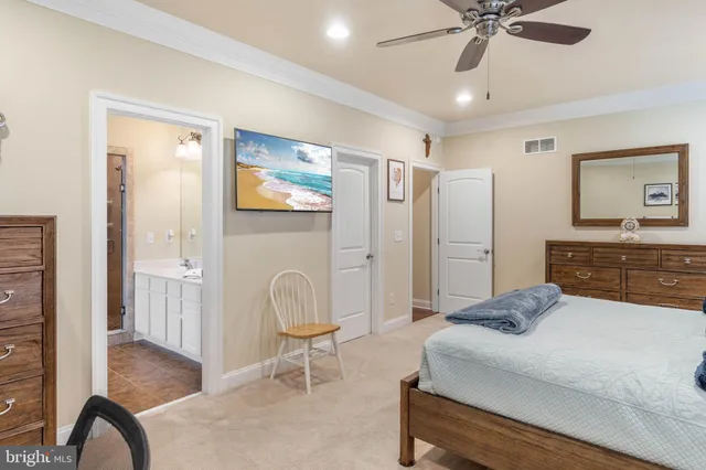 a spacious bedroom with a bed and a dresser