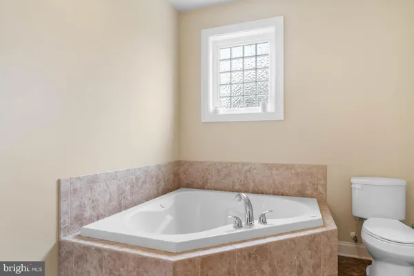 a bathroom with a toilet and bathtub