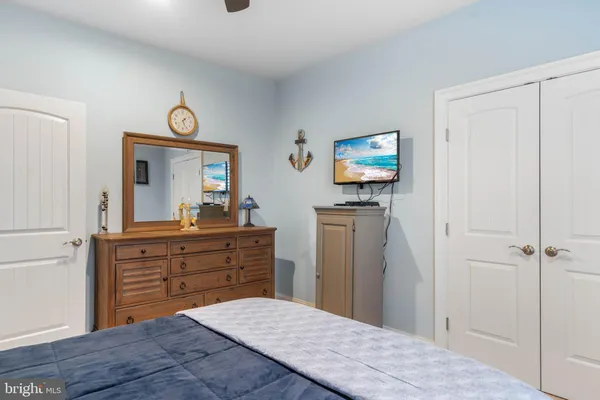 a bed room with a bed mirror and a table