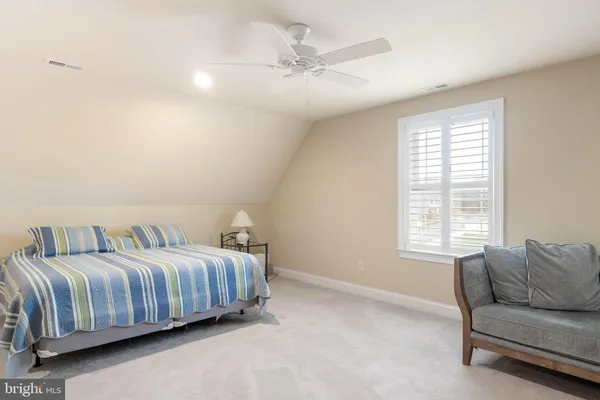 a bedroom with a bed couch and window